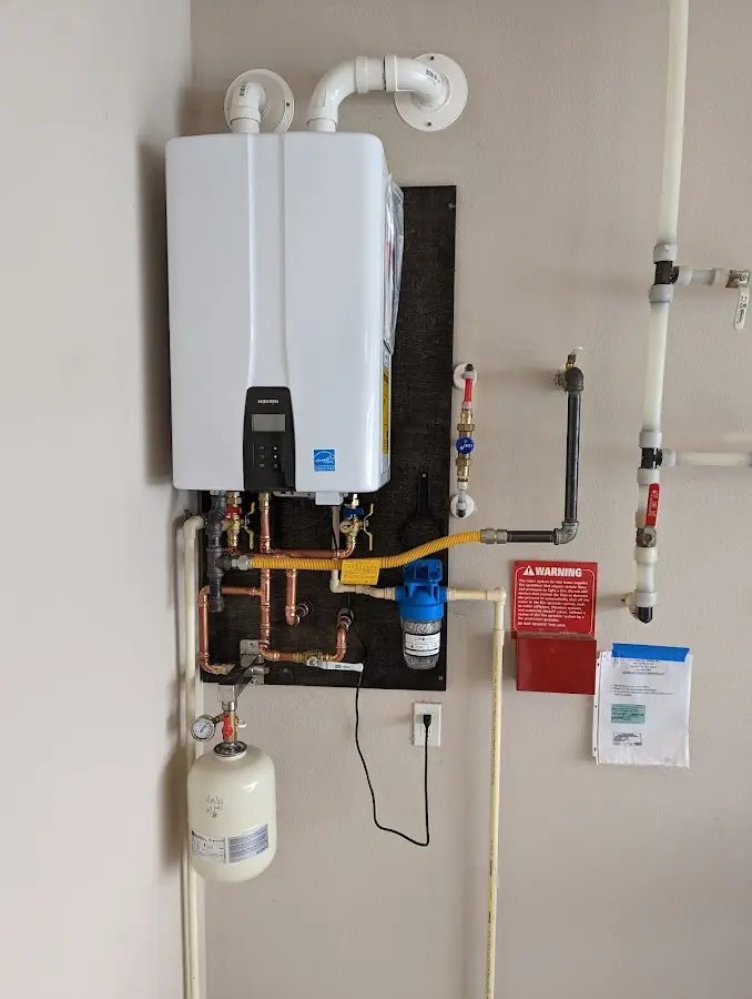 Professional plumber installing copper piping in a Great Neck Plaza home